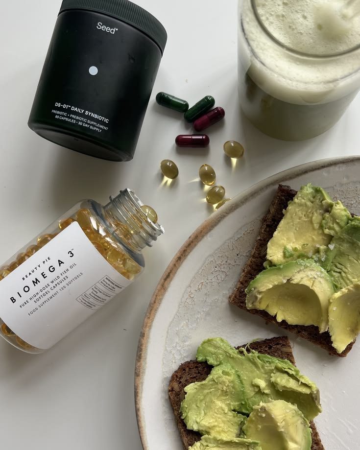 Omega-3 capsules and a probiotic next to a complete meal